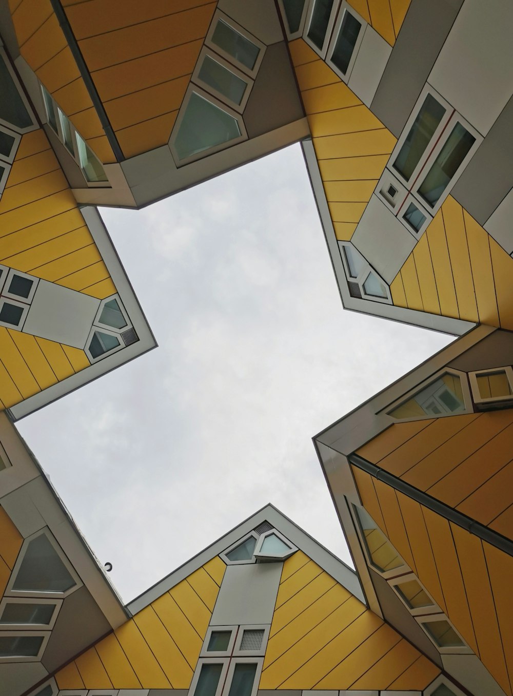 a group of buildings with windows and a sky background