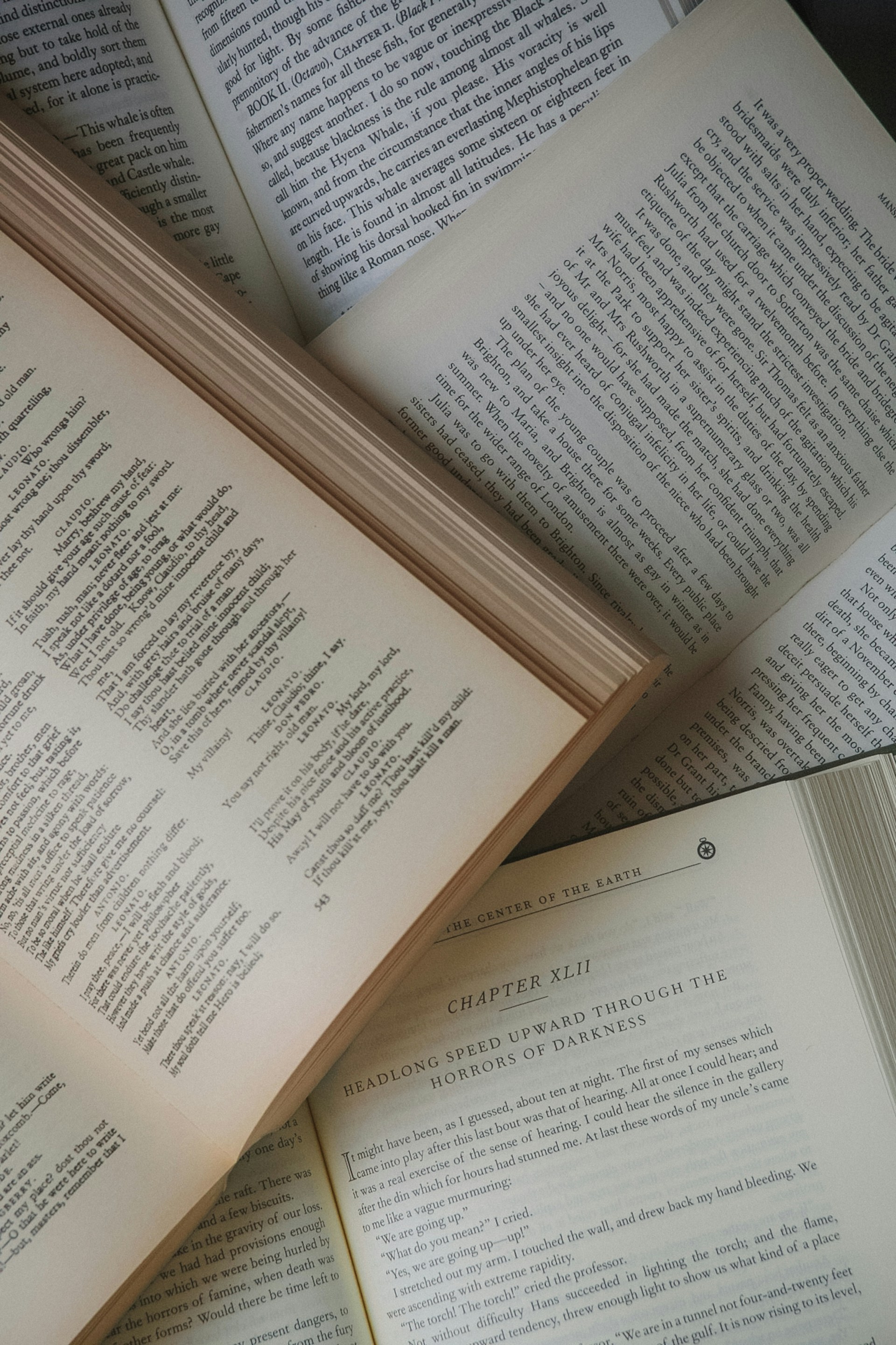 a pile of open books sitting on top of each other
