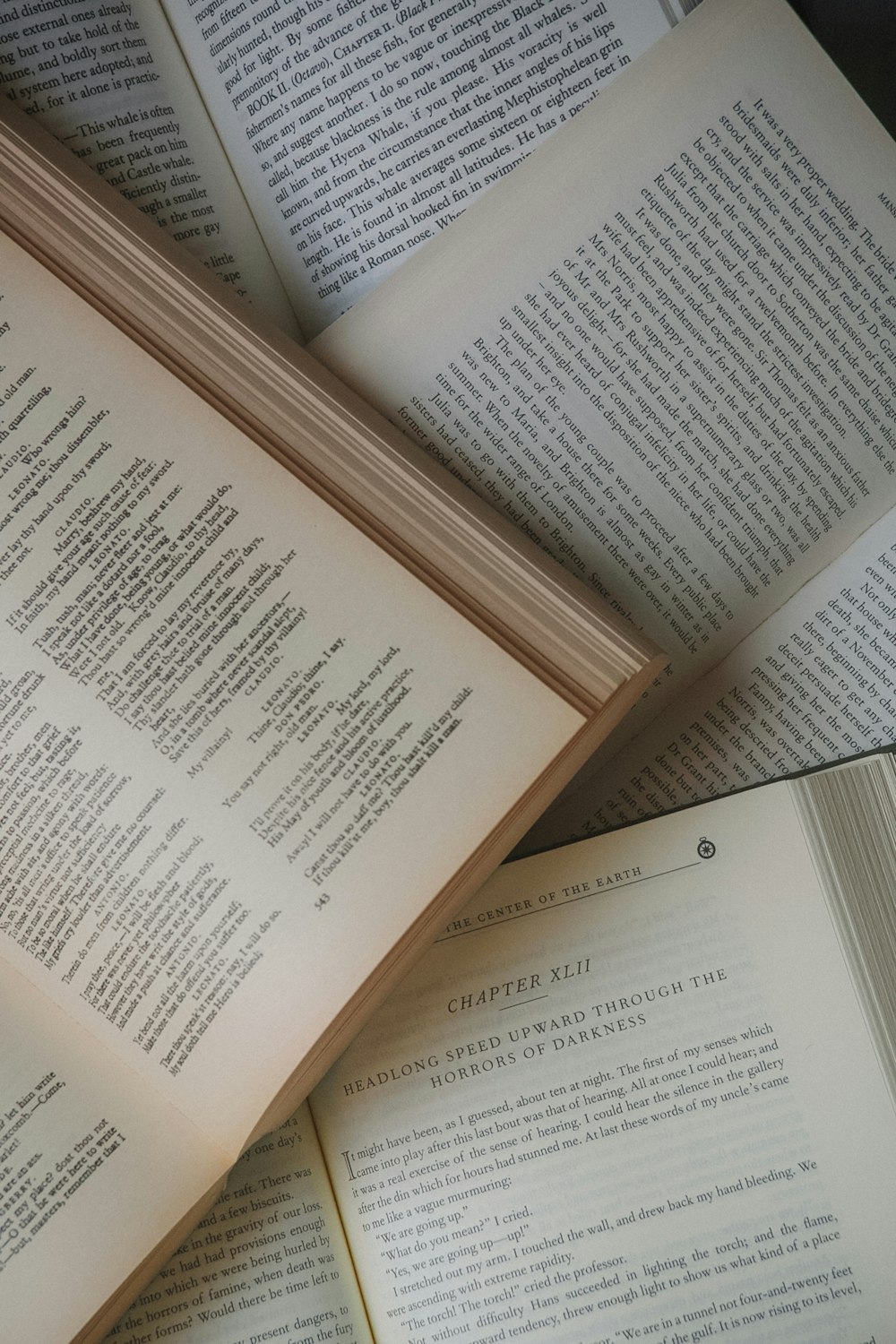 a pile of open books sitting on top of each other