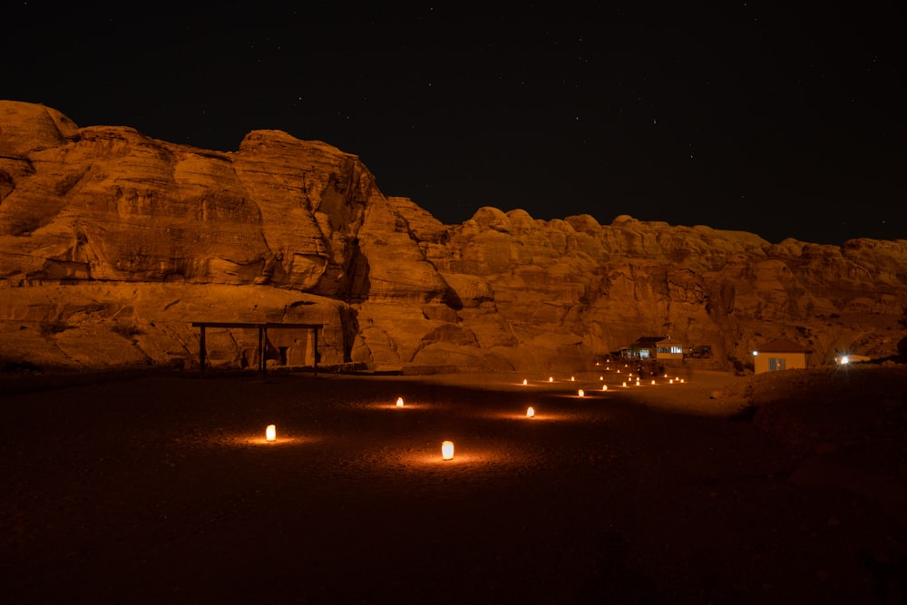 a group of lit candles sitting in the middle of a desert