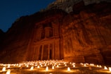 a group of candles lit up in front of a building