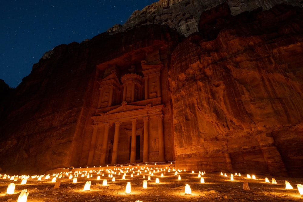 a group of candles lit up in front of a building