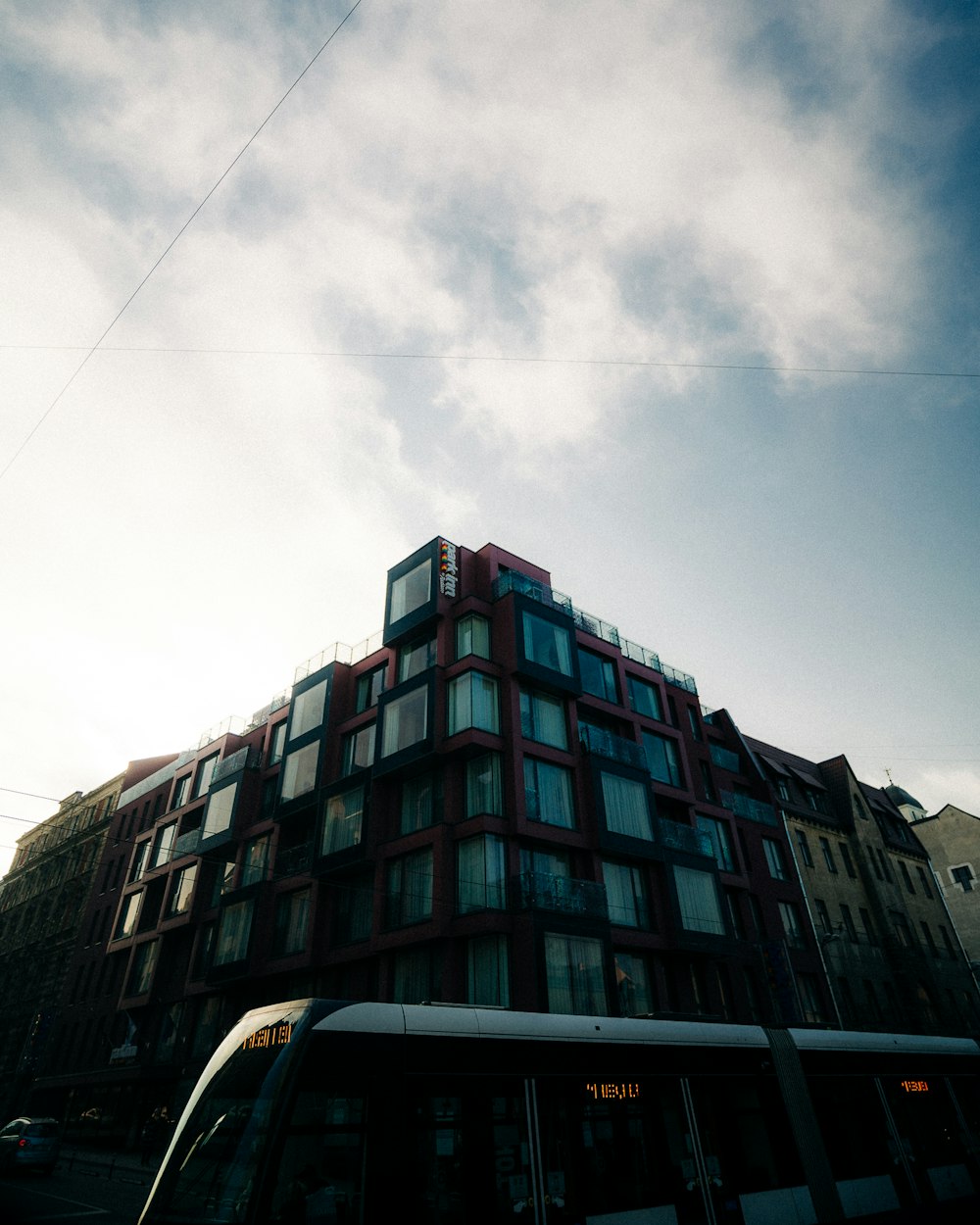 a bus parked in front of a tall building