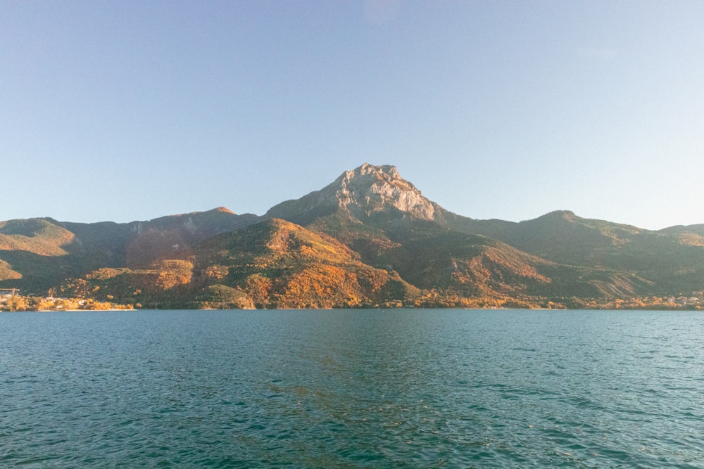 a large body of water with mountains in the background