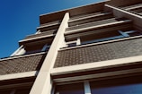 a tall building with windows and a sky background