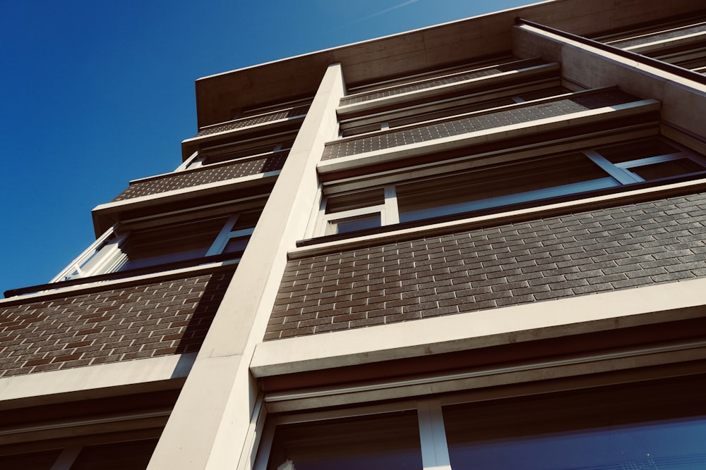 a tall building with windows and a sky background