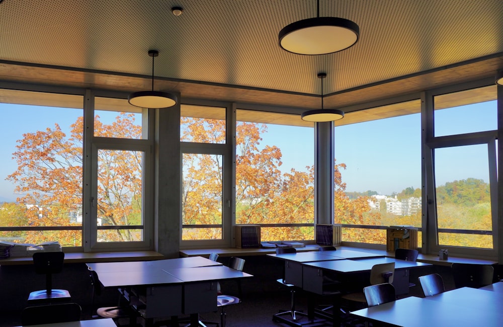 a classroom with a view of the trees outside the windows