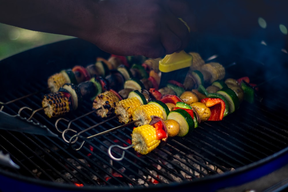 a person is grilling vegetables on a grill