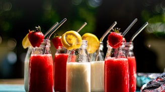 a table topped with three bottles filled with drinks