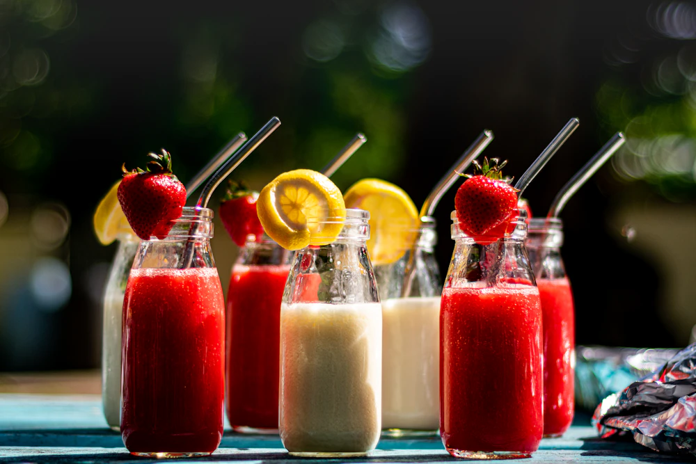 Bottled strawberry smoothies garnished with fresh strawberries