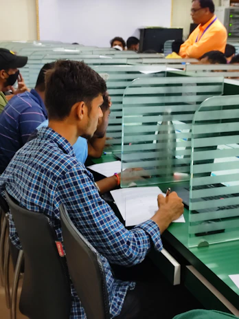 a group of men sitting at a table with papers
