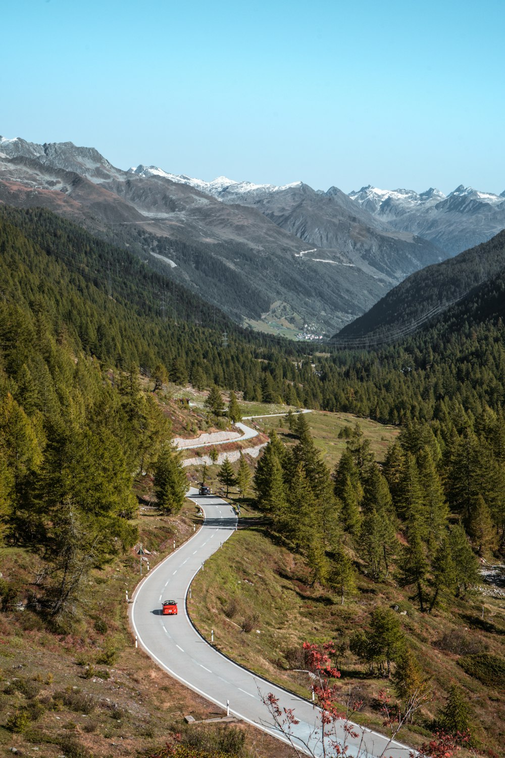 a car driving down a winding road in the mountains