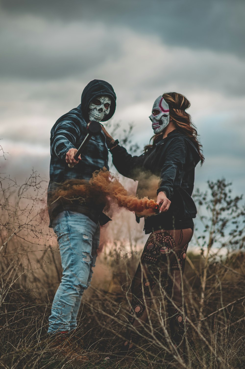 a man and a woman in skeleton makeup holding hands