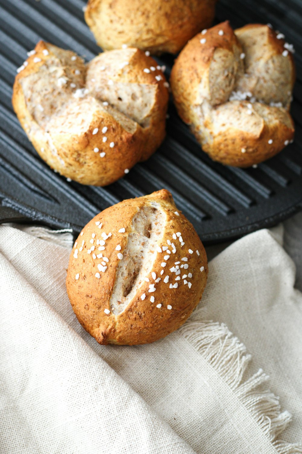 a close up of a hot dog buns on a grill