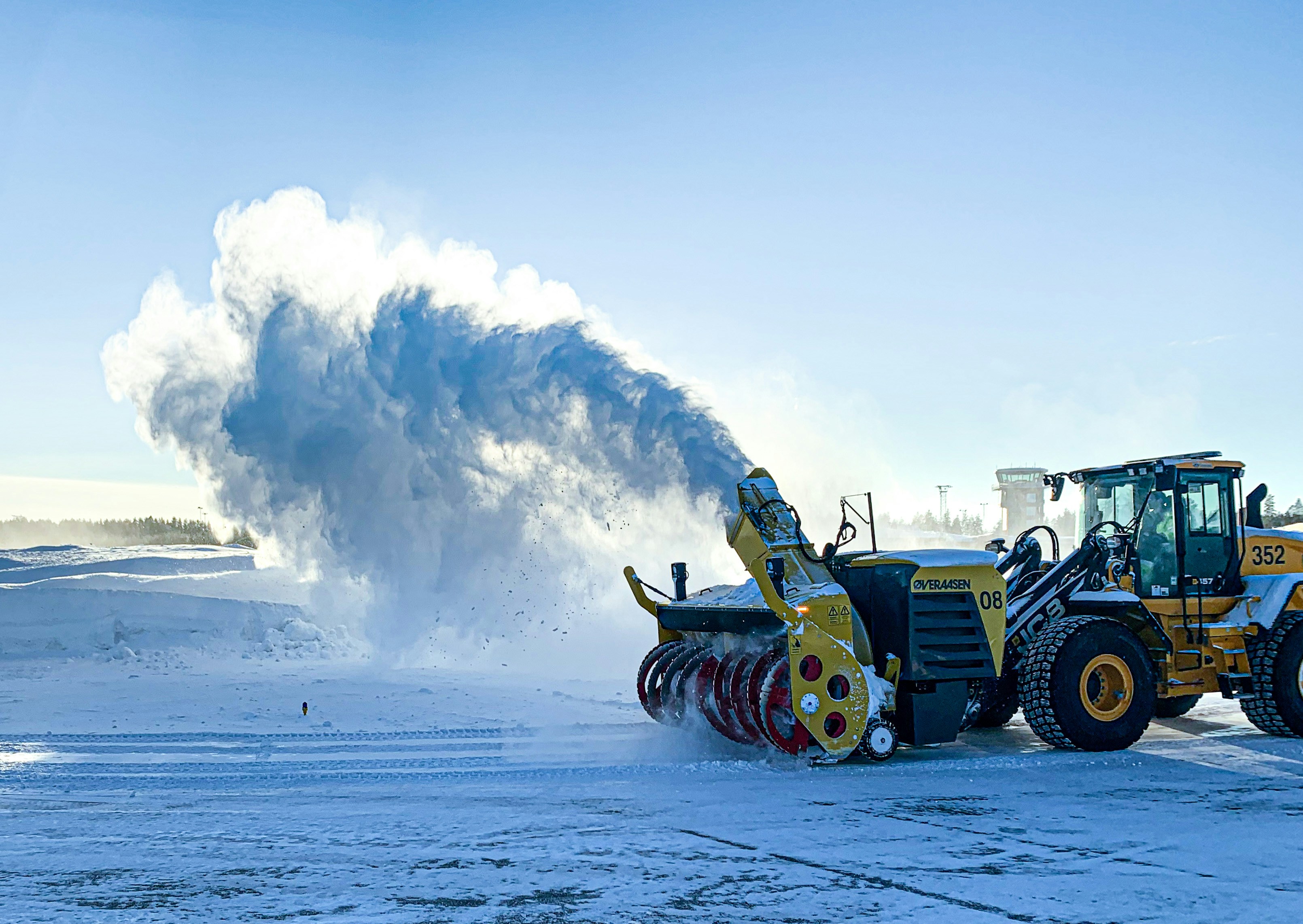a snow plow and a bulldozer in the snow, 