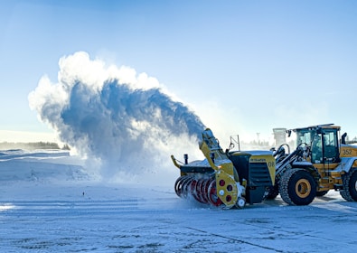 a snow plow and a bulldozer in the snow