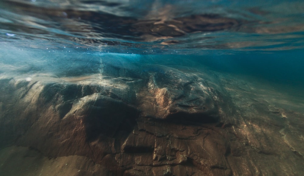 the underwater view of a rock formation in the ocean