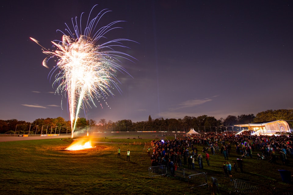 A crowd watches fireworks.