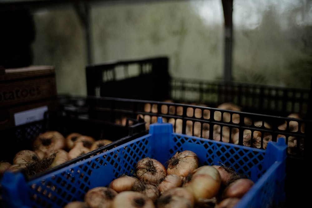 a crate full of onions sitting on top of a table