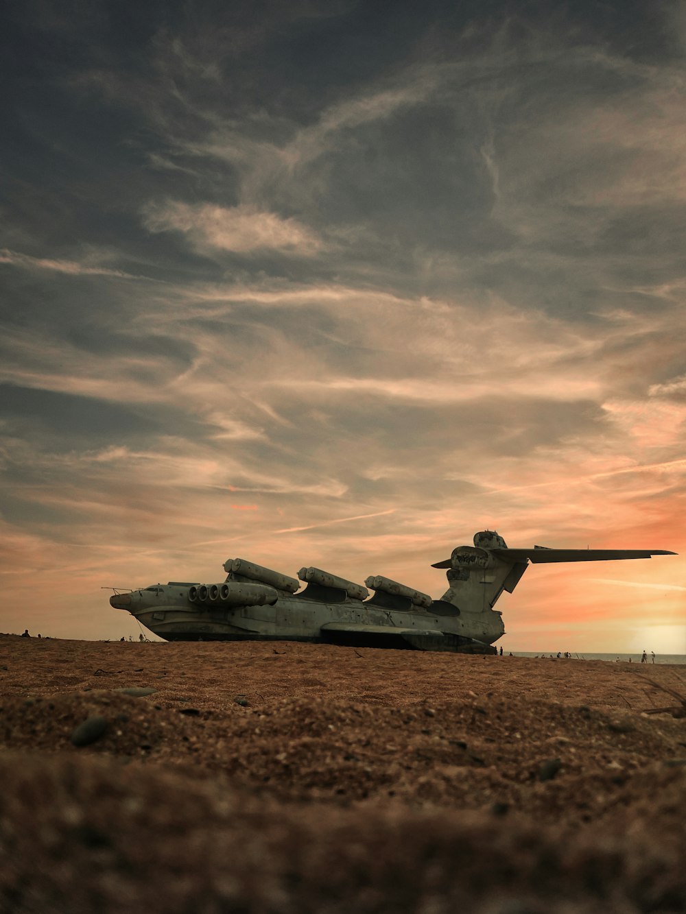 a large airplane sitting on top of a dry grass field