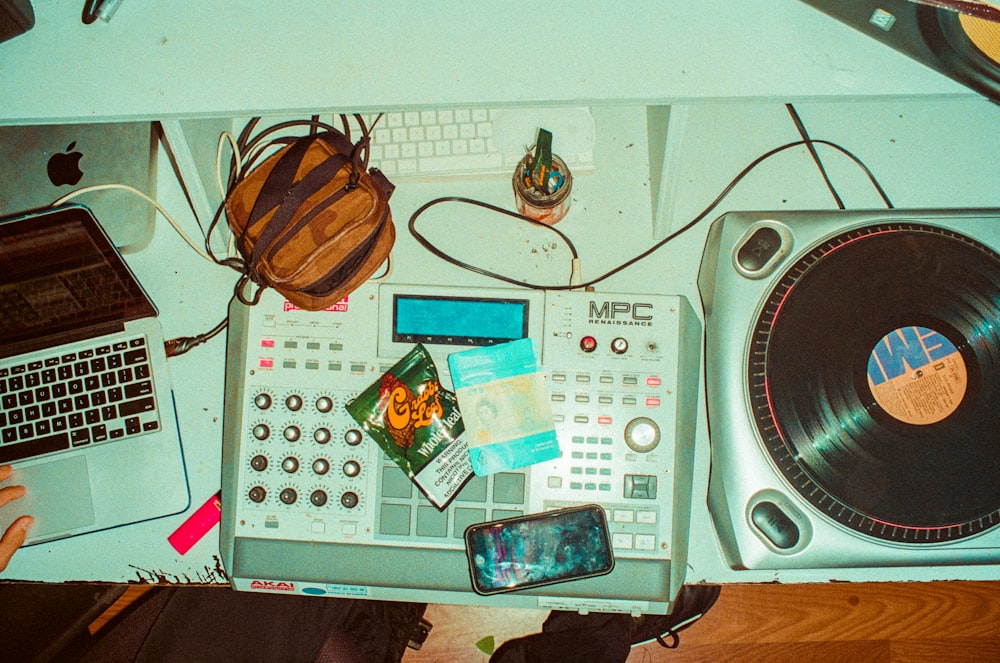 a record player and a laptop on a table