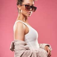 a woman wearing sunglasses and a sweater