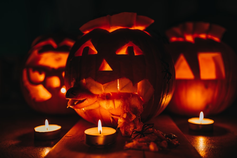 a group of carved pumpkins sitting on top of a table