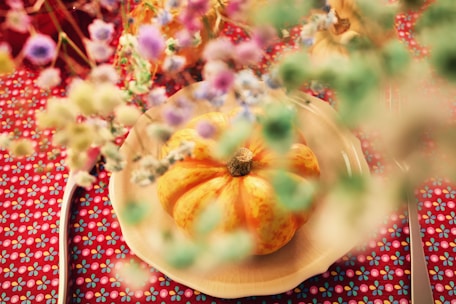 a white plate topped with a yellow pumpkin