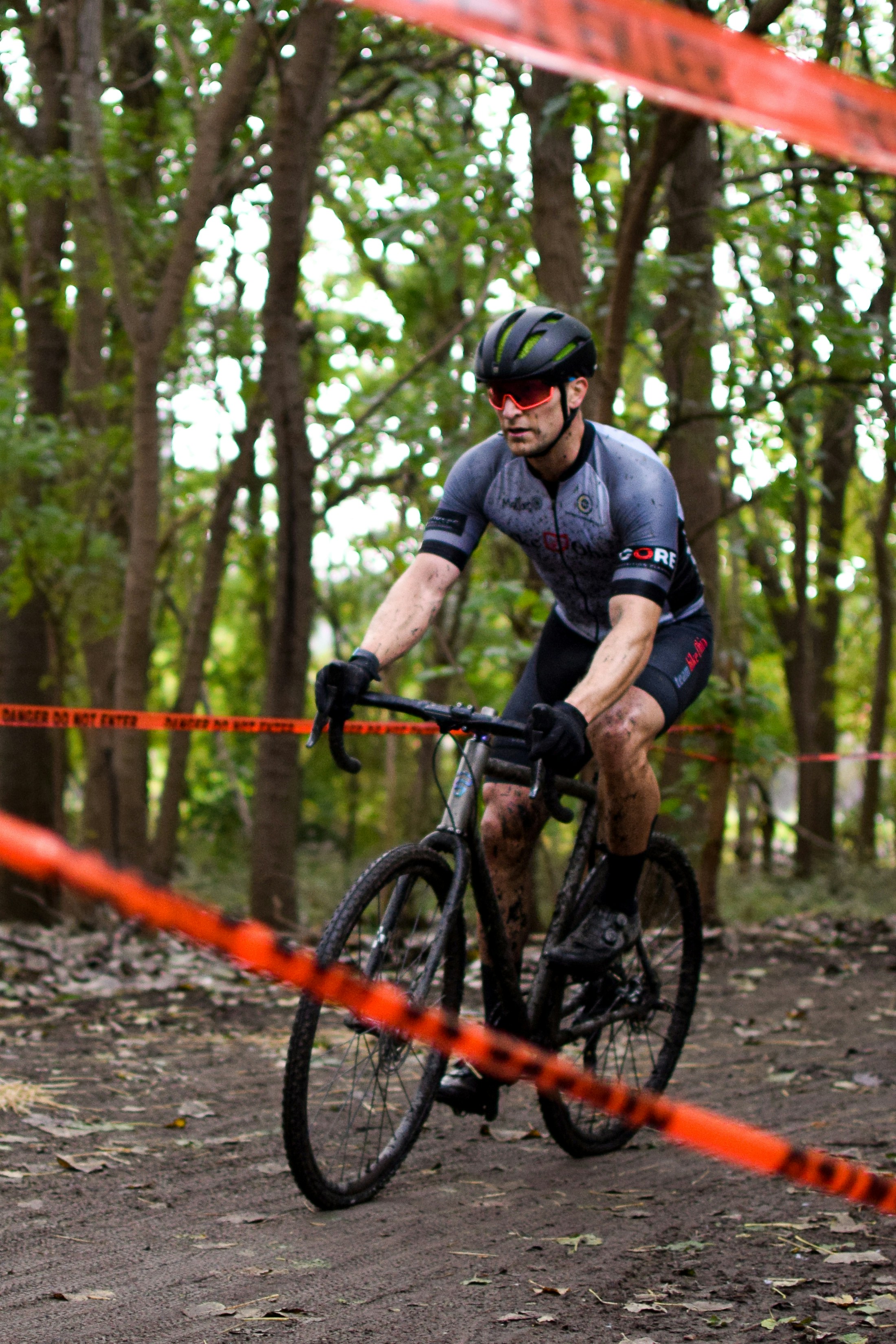 a man riding a bike through a forest