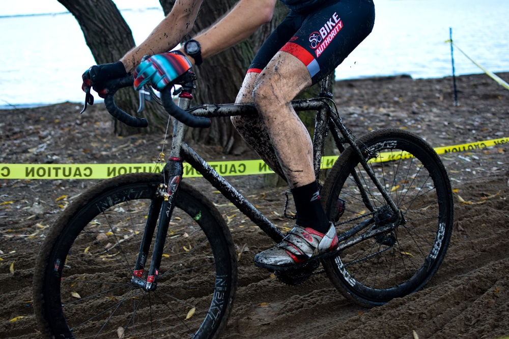 a man riding a bike down a dirt road