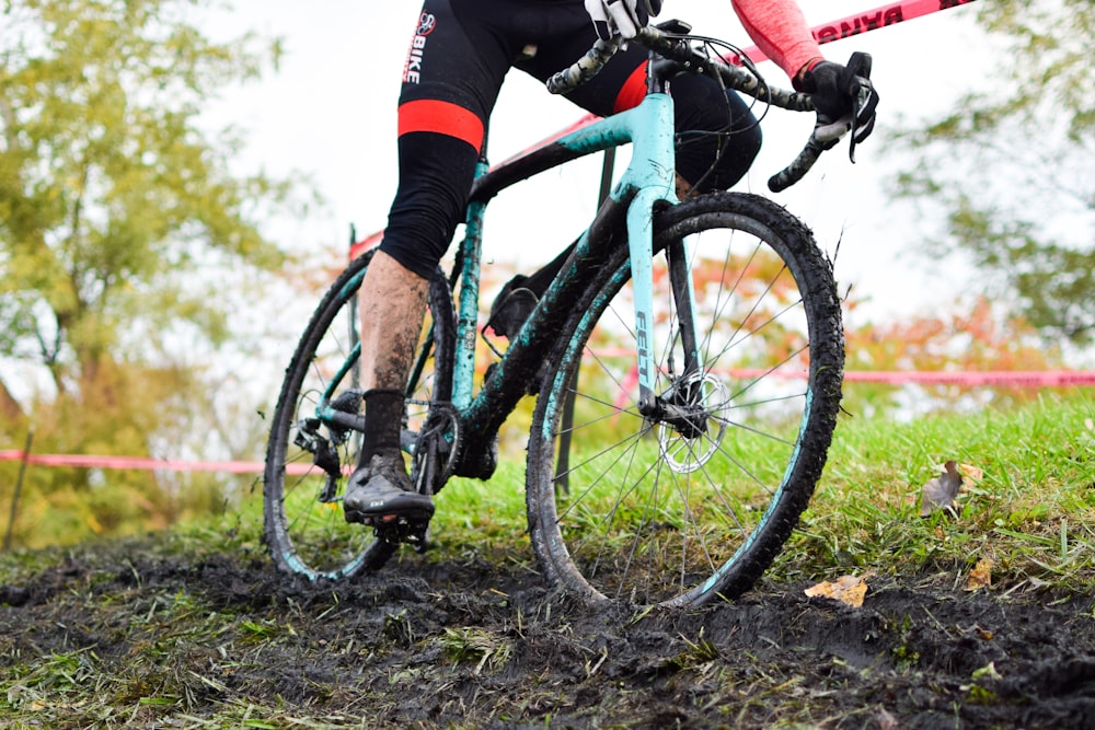 a person riding a bike on a muddy trail