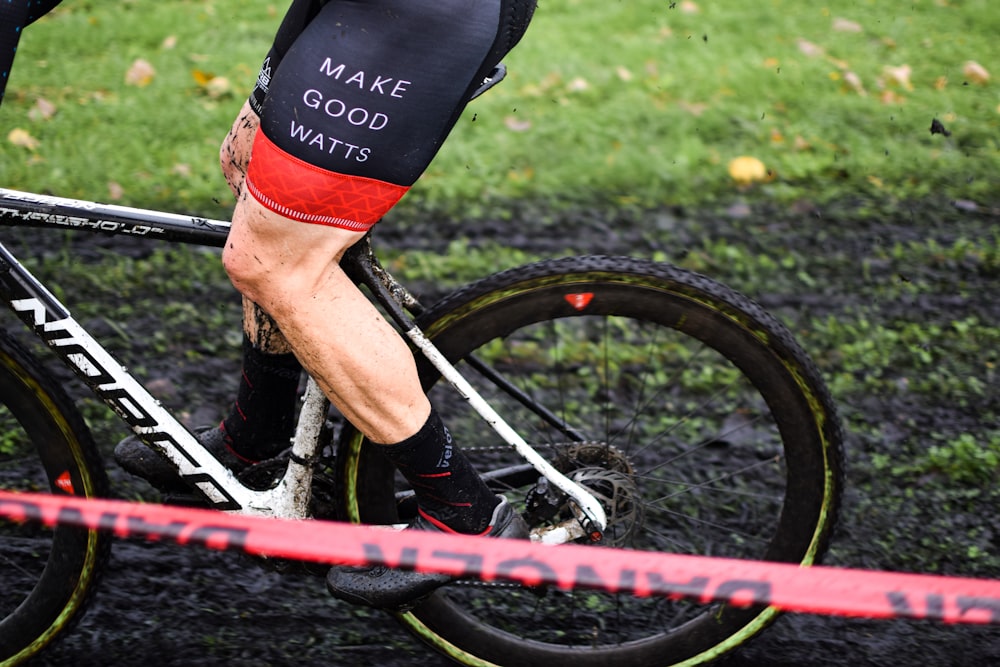 a close up of a person riding on the back of a bicycle