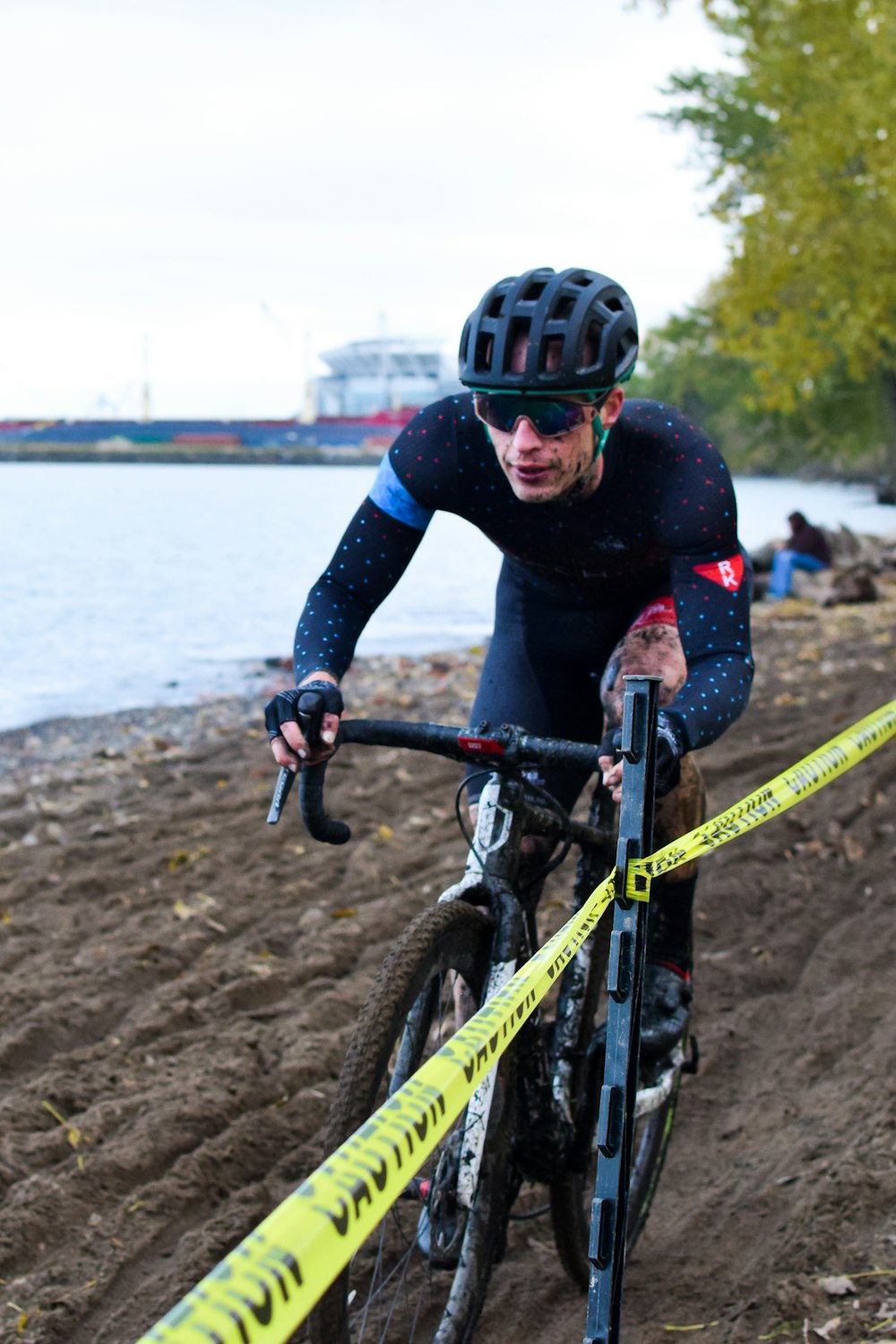 a man riding a bike down a muddy road