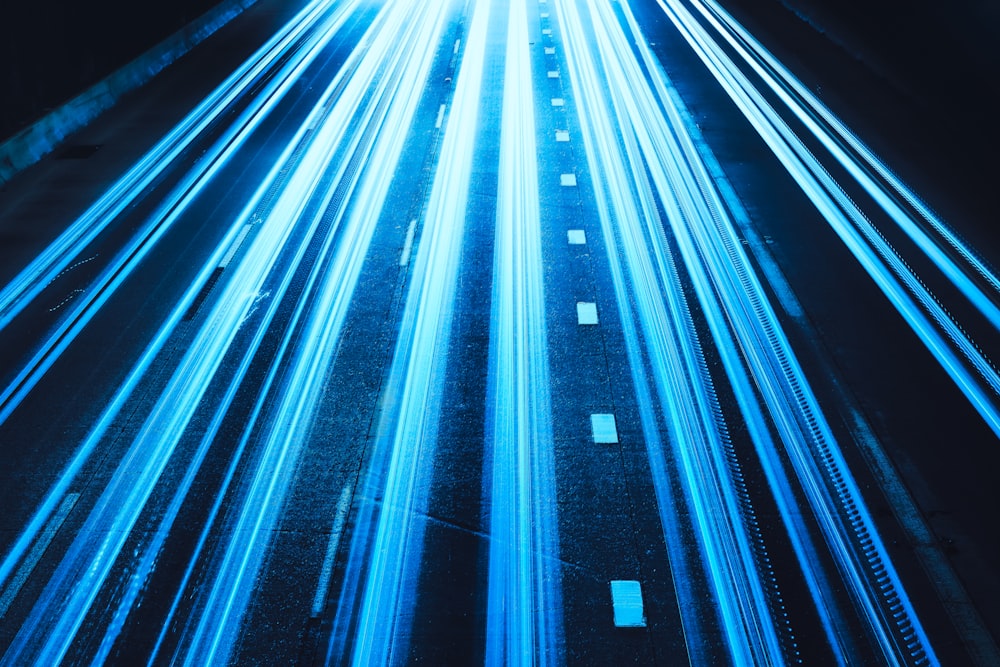 a long exposure photo of a highway at night