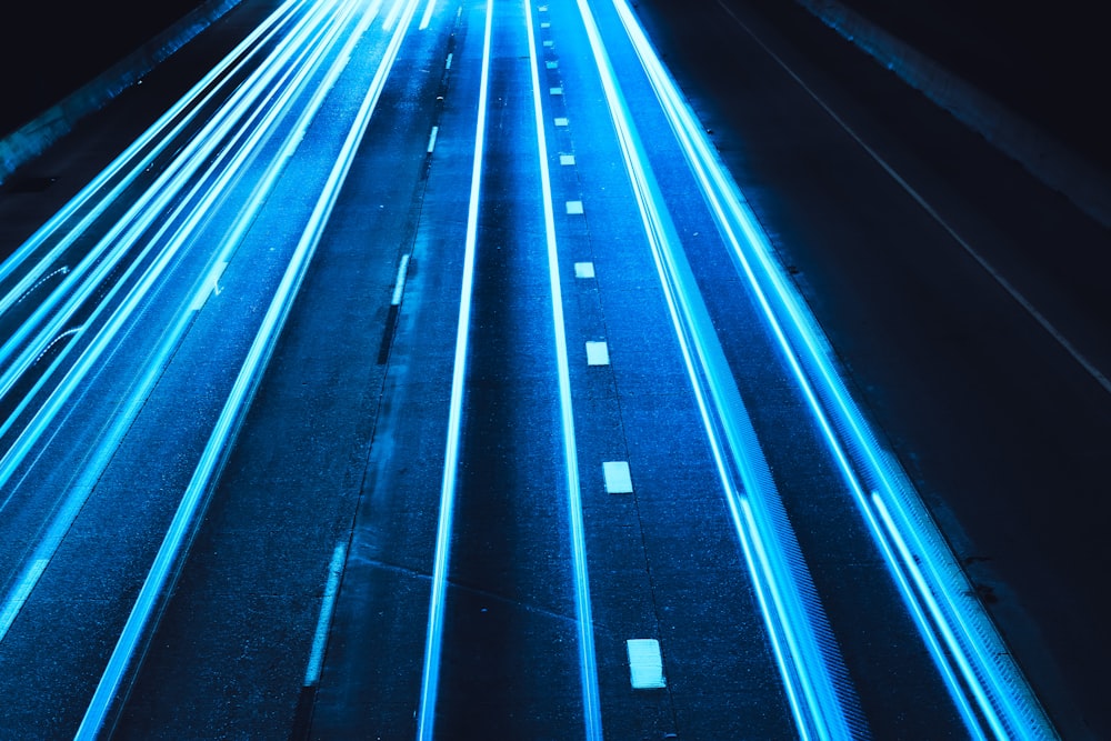 a long exposure photo of a highway at night