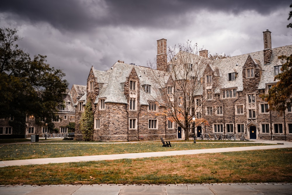 a large stone building with a tree in front of it