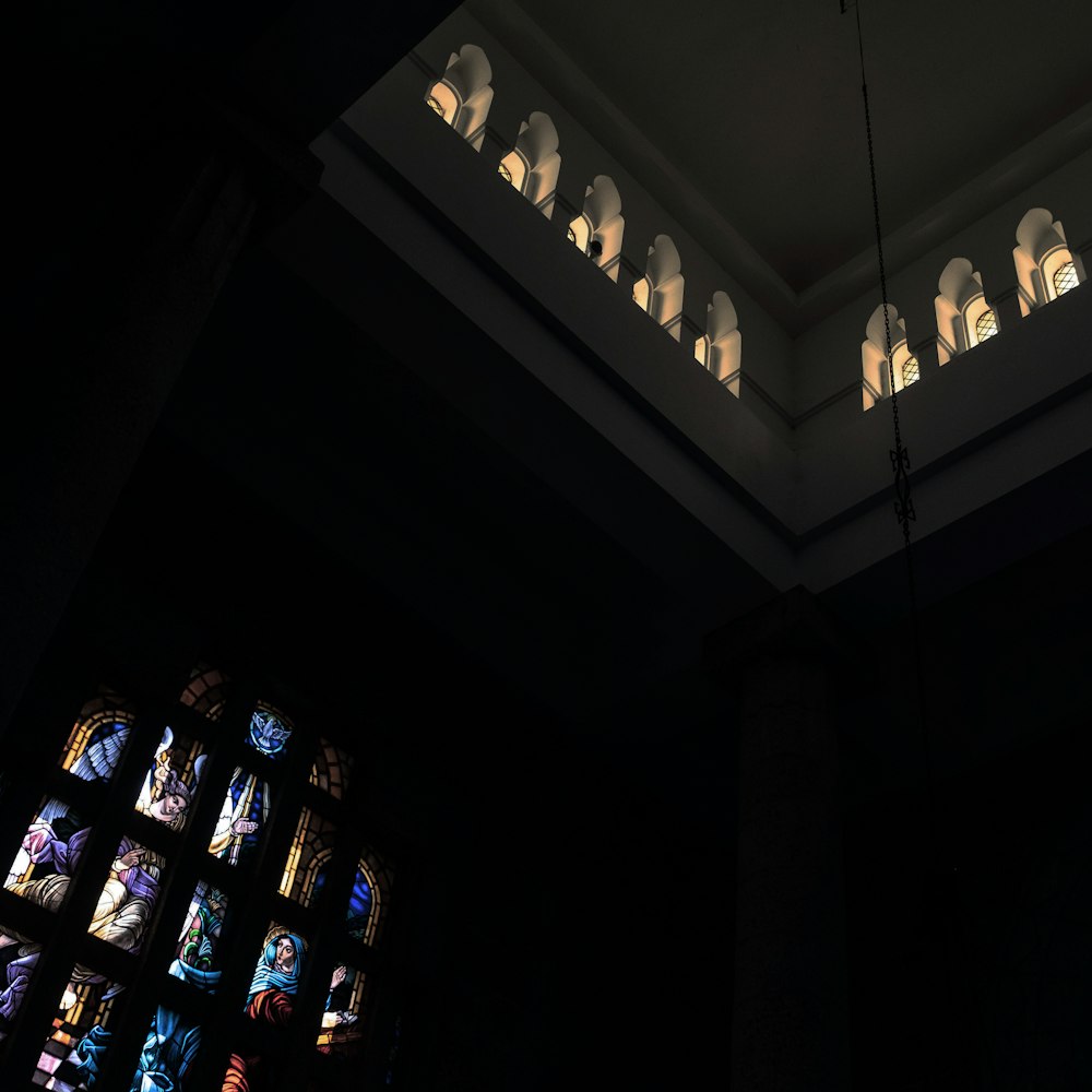 a large stained glass window in a dark room