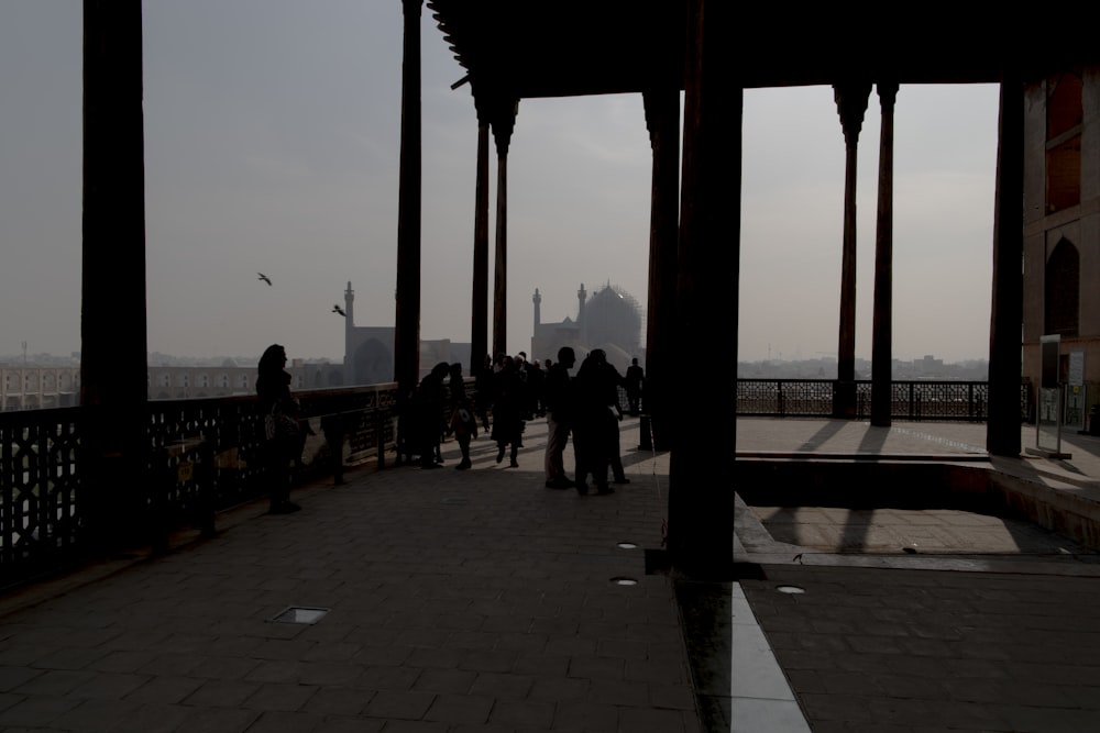 a group of people walking across a bridge