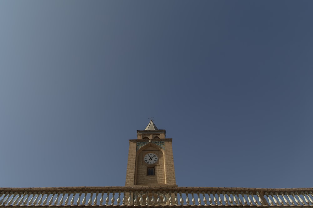 a tall clock tower with a clock on each of it's sides