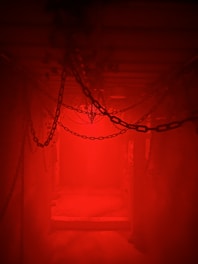 a red light is shining in a dark room