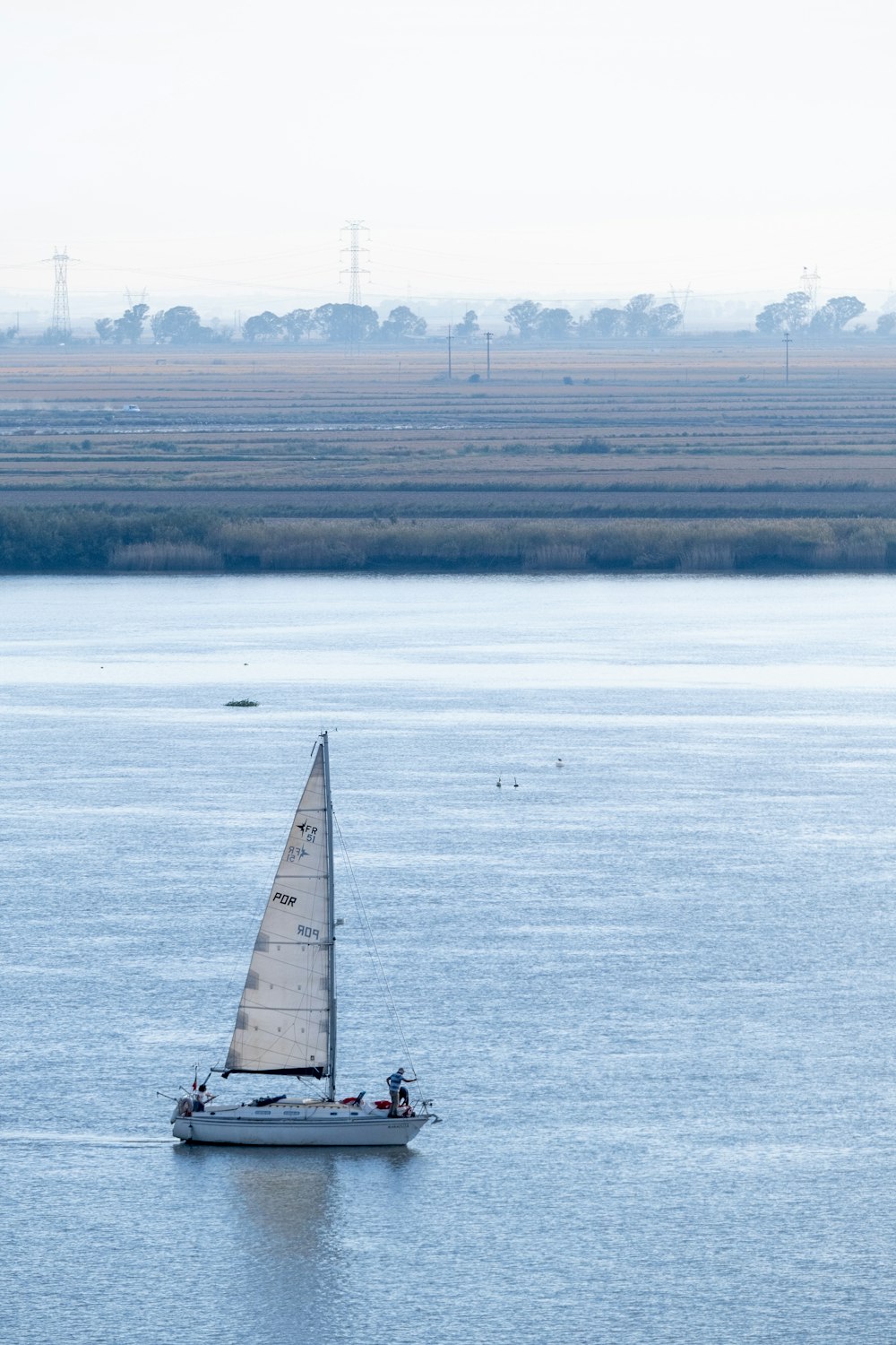 a sailboat in the middle of a large body of water