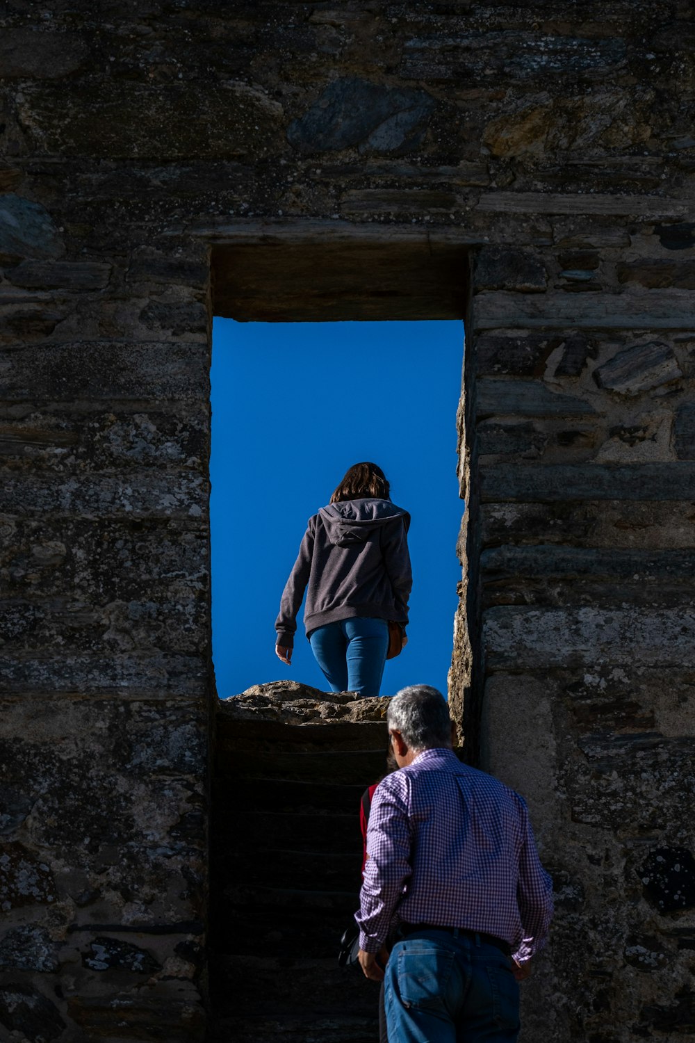 a man and a woman walking up a set of stairs