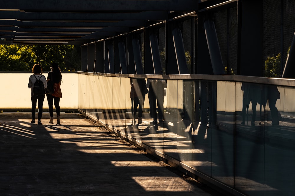 a group of people walking across a bridge