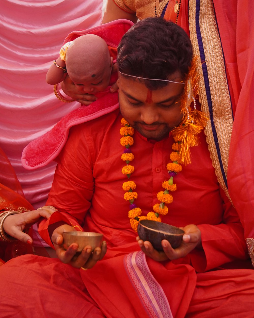 a man in a red outfit holding a cell phone