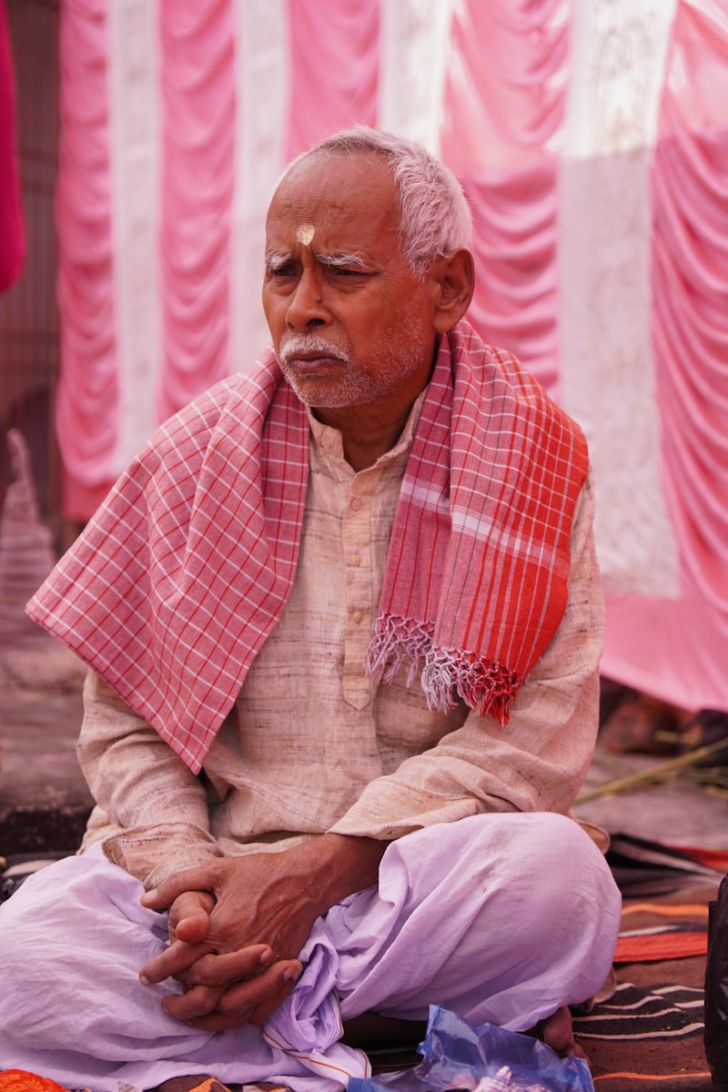 Senior man practicing meditation in a seated cross-legged position, demonstrating mindfulness and inner calm for adults over 65