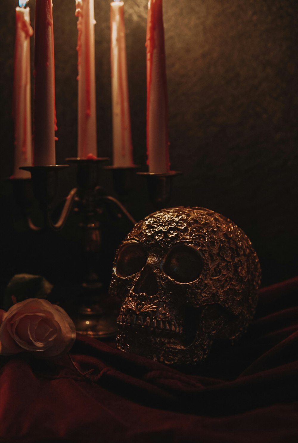 a skull sitting next to a candle holder