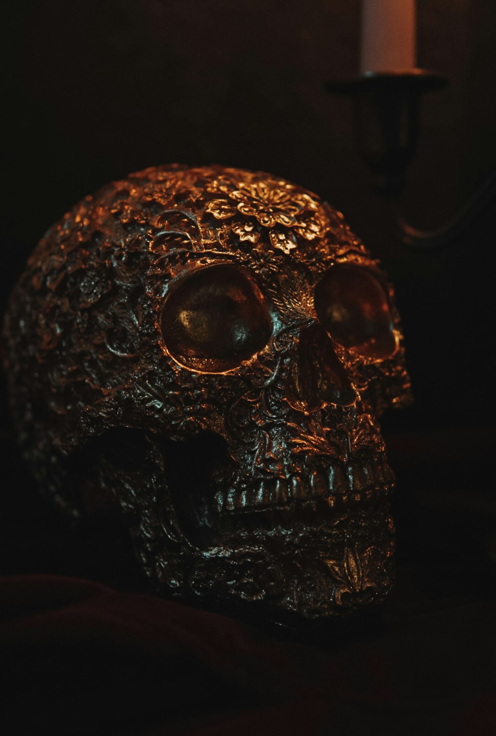 a skull with a candle in the background