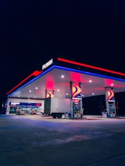 a gas station lit up with red, white and blue lights