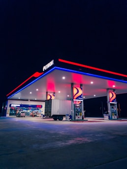 a gas station lit up with red, white and blue lights