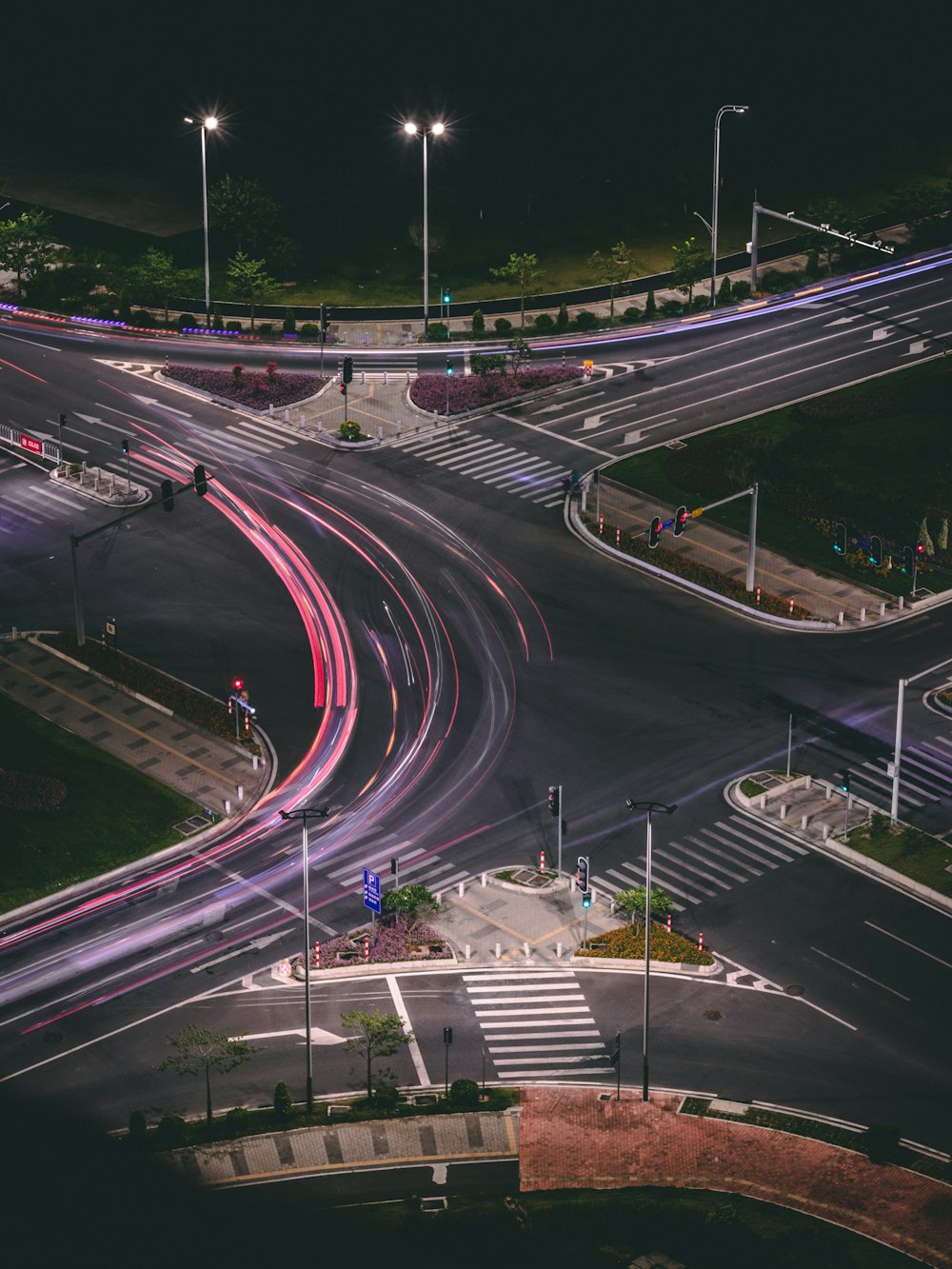 a city intersection at night with traffic lights